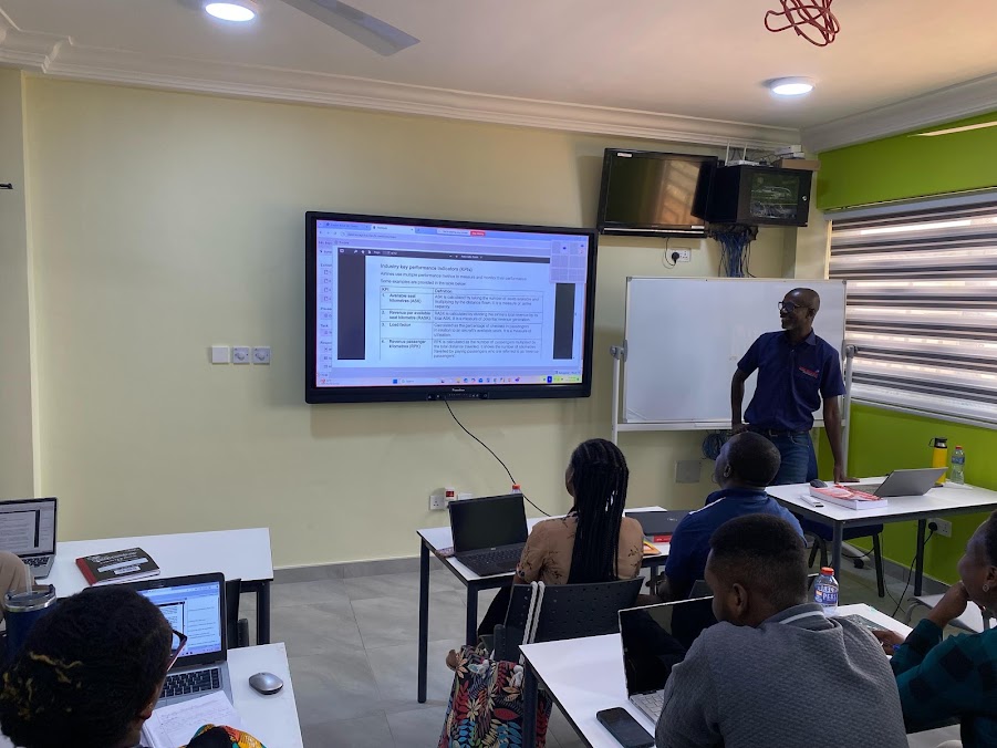 Tutor teaching learners with a large interactive display